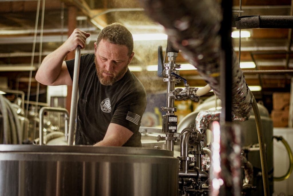 Allan Conger brewing at 1912 Brewing Company in 2018 (Photo by Jackie Tran.)