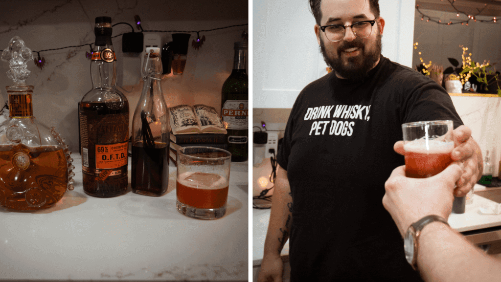 a man holding a glass of beer on a table