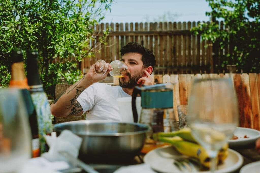 a person sitting at a table eating food