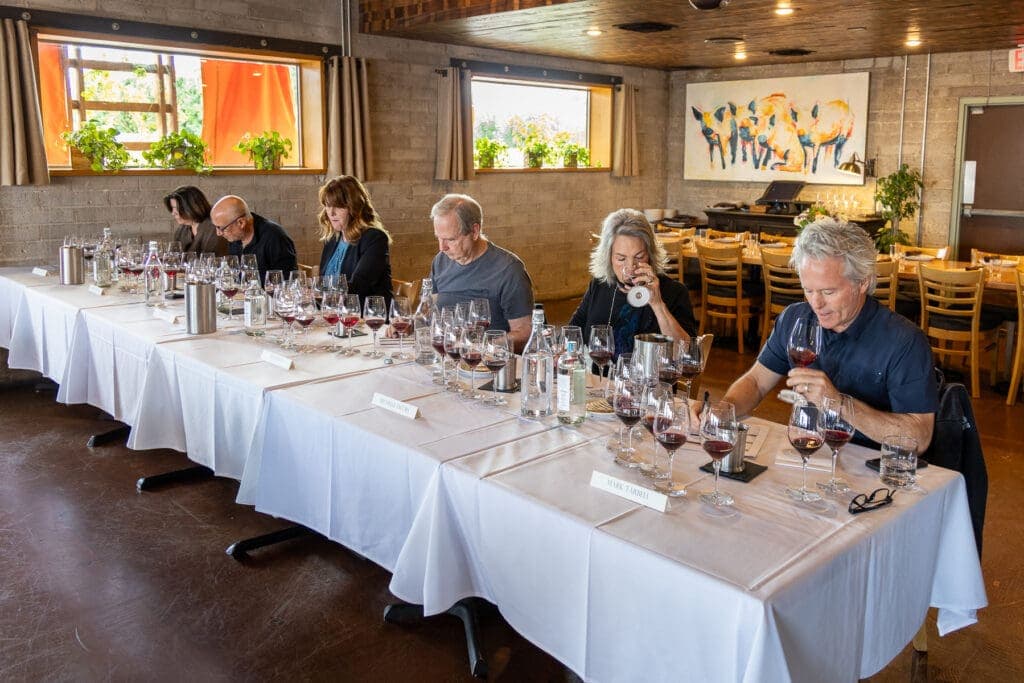 a group of people sitting at a table with wine glasses