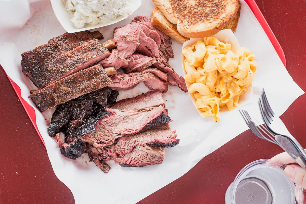 Three-meat plate with ribs, brisket, tri-tip, potato salad, and mac and cheese at Holy Smokin' Butts (Credit: Jackie Tran)
