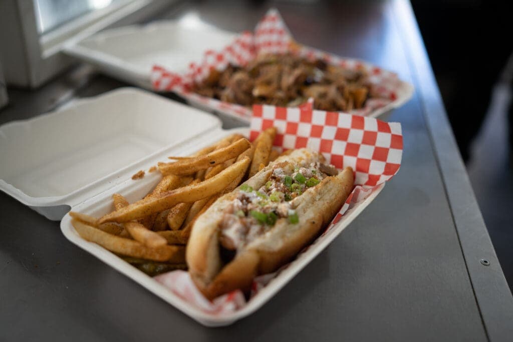 a tray of hot dogs sitting on a table