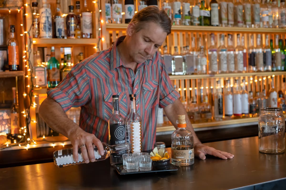 Proprietor Doug Smith pouring mezcal at Exo Bar (Credit: Jaime Lawhorn)
