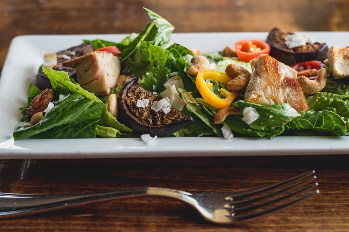 Coconut-Eggplant Chicken Salad with romaine lettuce, grilled Nadia eggplant, cashes, and toasted coconut flakes with minted coconut dressing, seared chicken, and sweet and hot peppers at Feast (Credit: Jackie Tran)