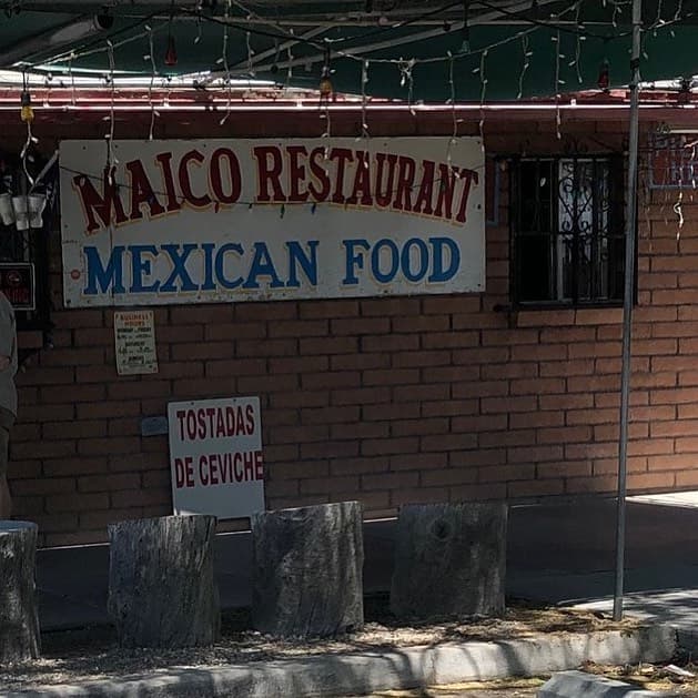 a sign in front of a brick building