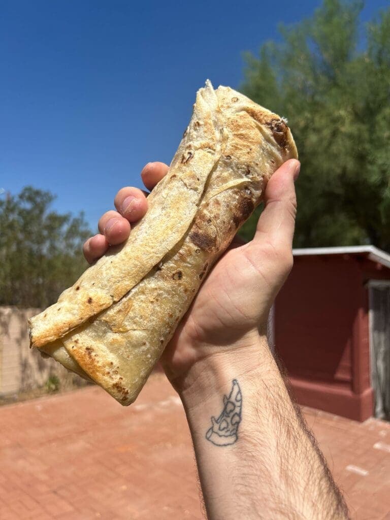a hand holding a piece of wood
