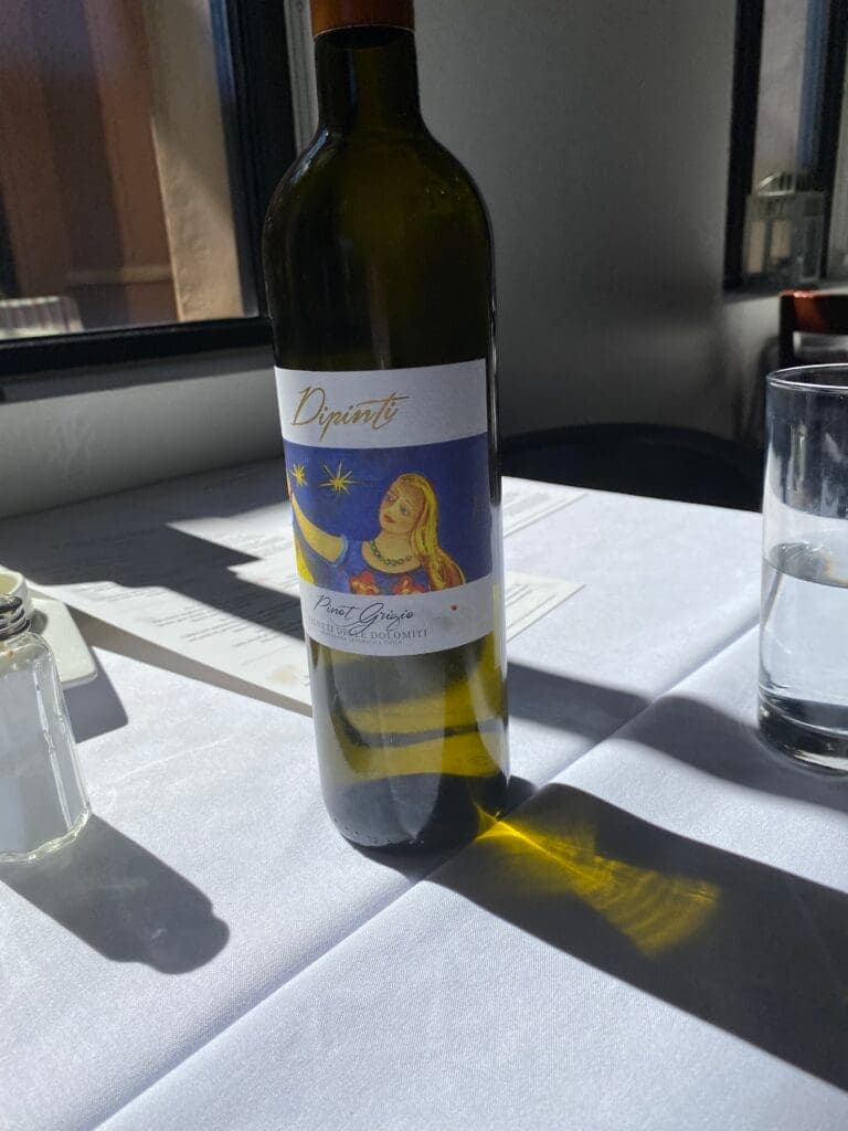 a bottle of wine and a glass of beer on a table