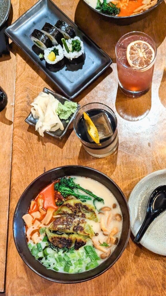 a bowl of food sitting on top of a wooden table