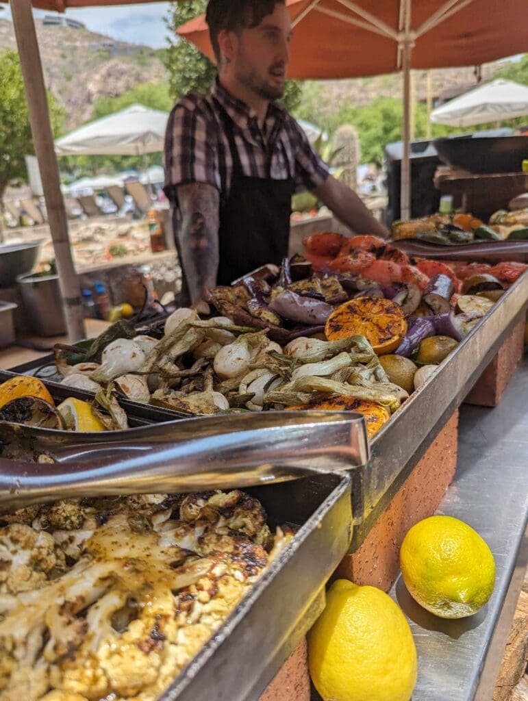 a person standing in front of a tray of food