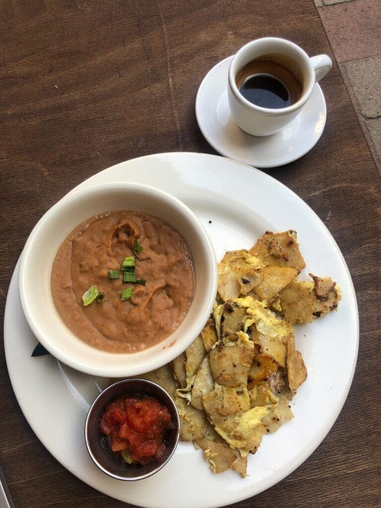 a plate of food and a cup of coffee