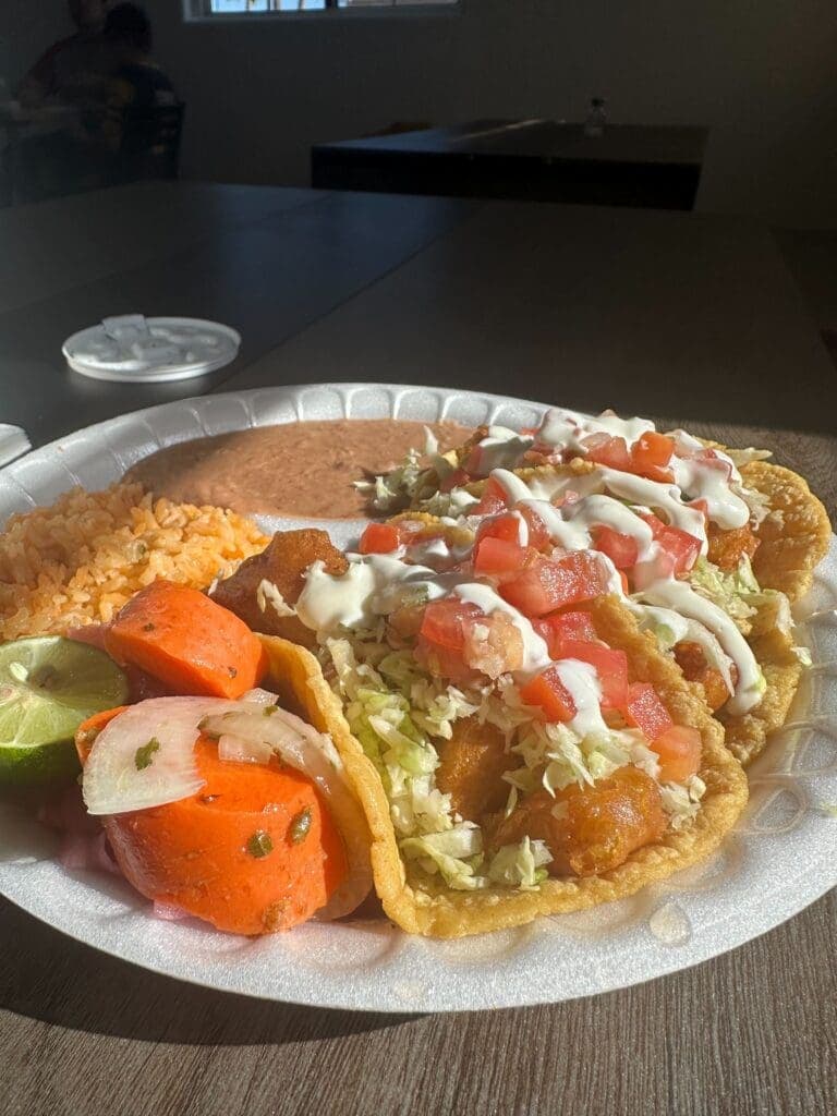 a plate of food with a slice of pizza