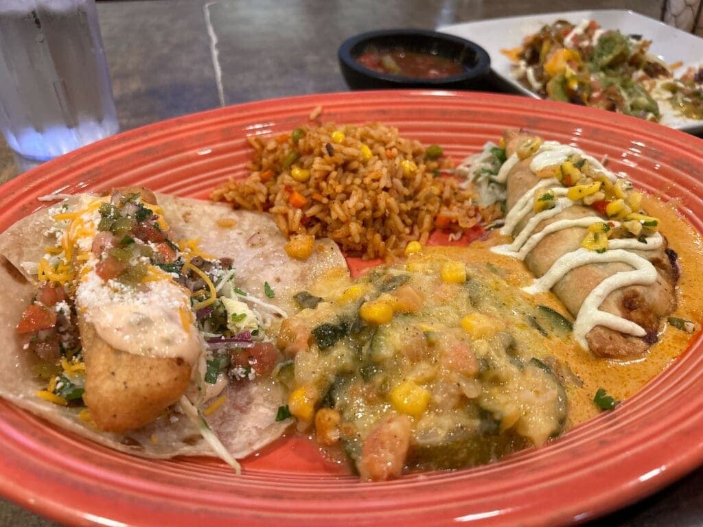 a plate of food with rice meat and vegetables
