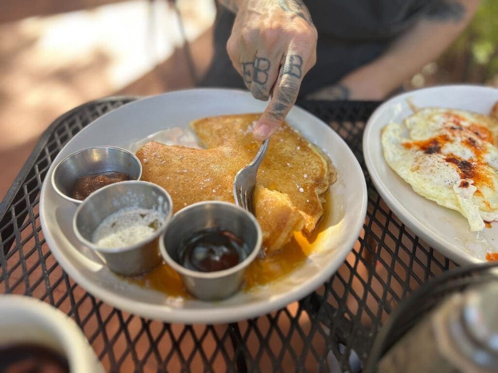a plate of food and a cup of coffee on a table