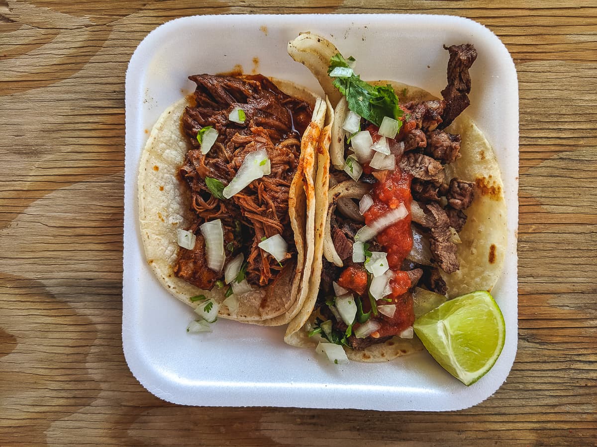 Birria taco and bistek encebollado taco at El Taco Rustico
