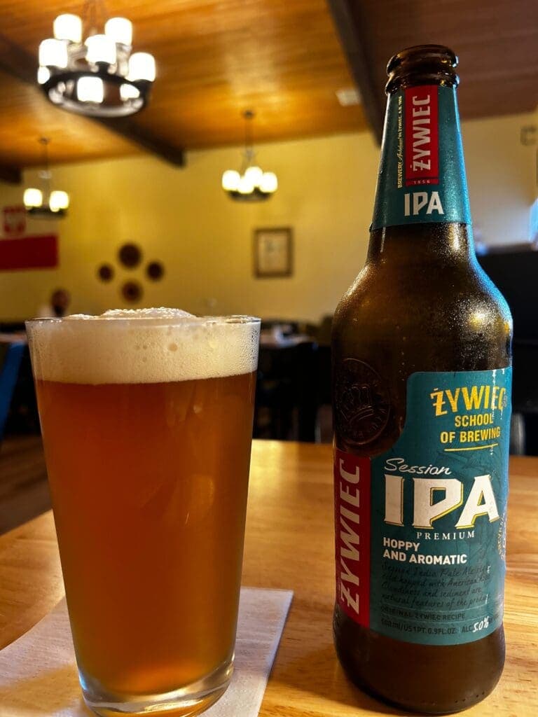 a close up of a bottle and a glass of beer on a table