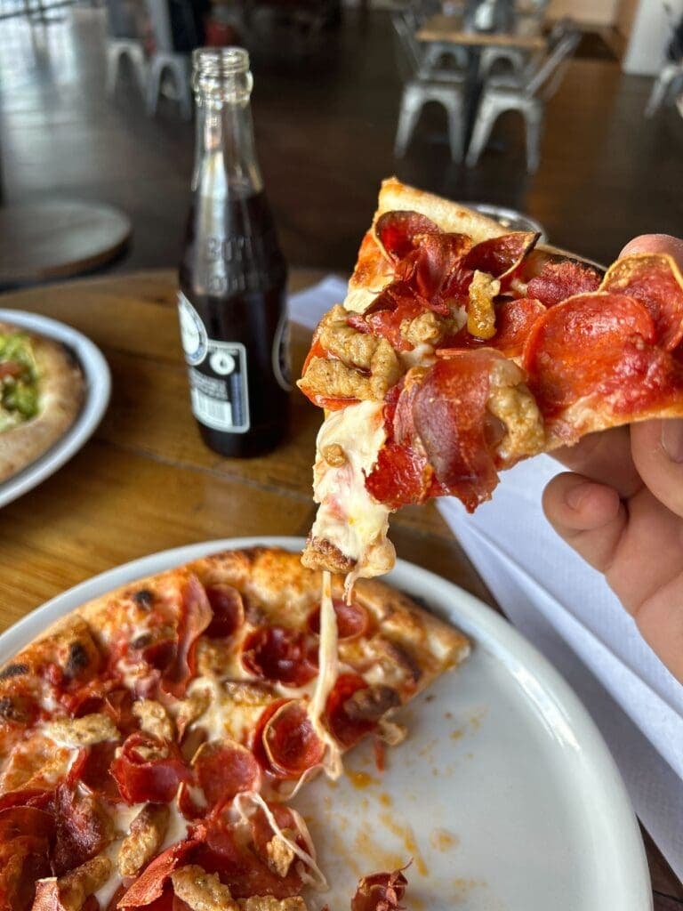 a plate of food with a slice of pizza