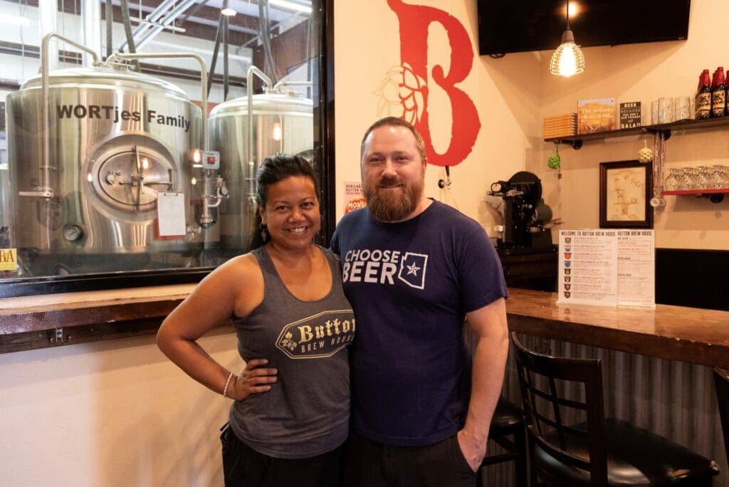 a man and a woman standing in front of a restaurant