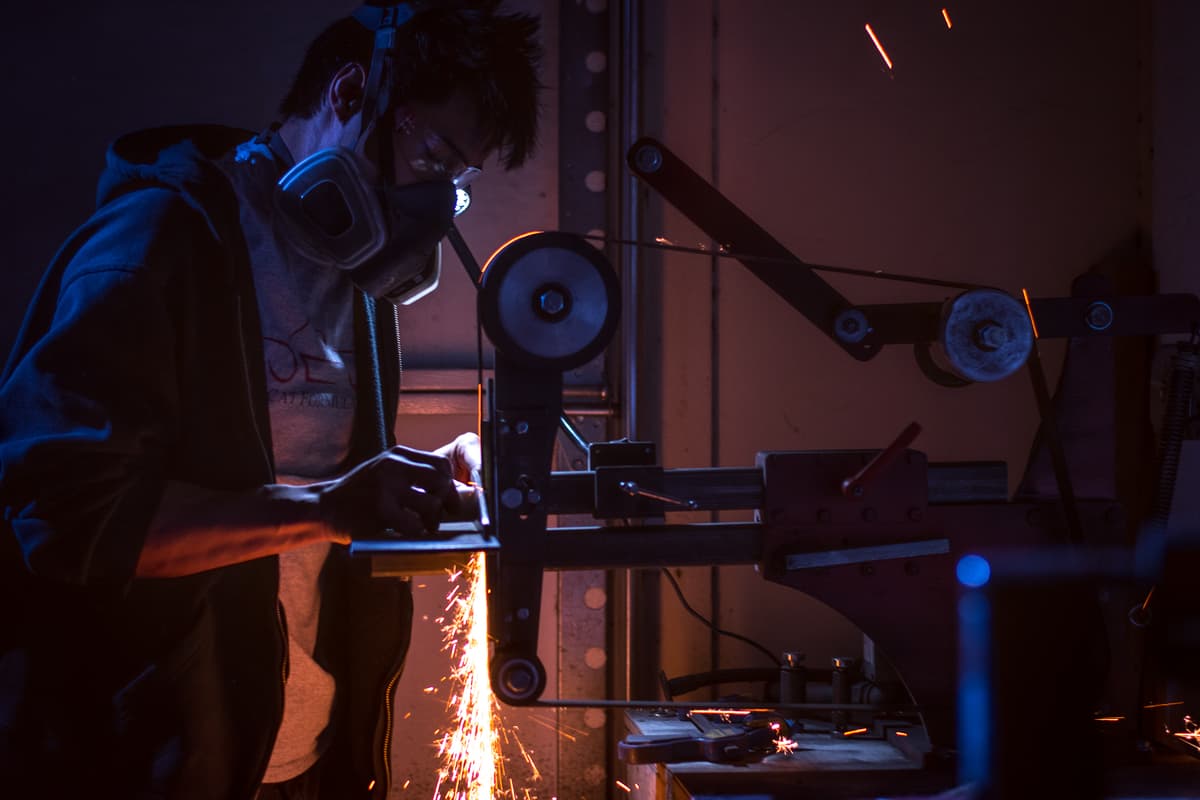 Don Nguyen of Don Nguyen Knives grinding a knife (Credit: Jackie Tran)