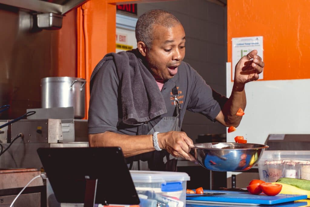 Chef Brian Hill preparing veggies for a saute at Chef Brian's Comfort Kitchen (Photo by Jackie Tran)
