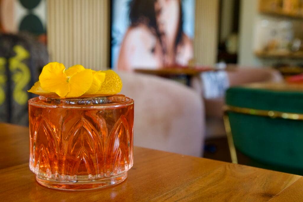 a glass of orange juice on a table
