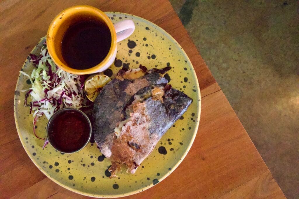 a plate of food and a cup of coffee