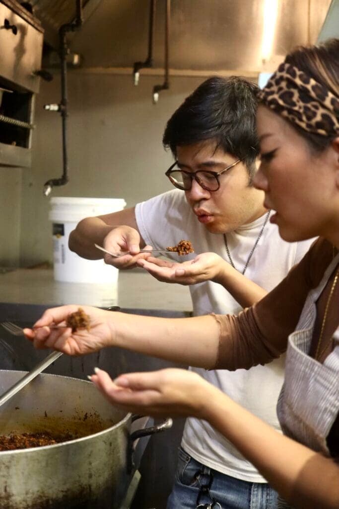 a woman cooking in a kitchen preparing food