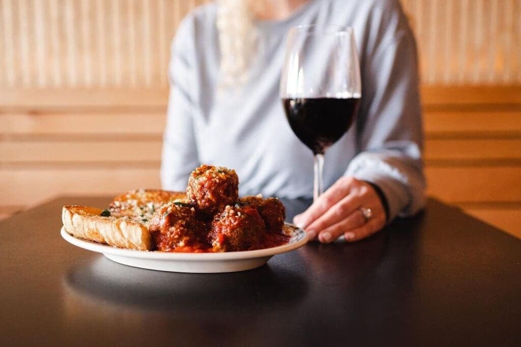 a person sitting at a table with a plate of food