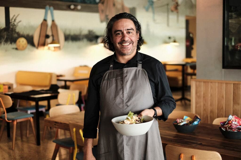 a person sitting at a table with a plate of food