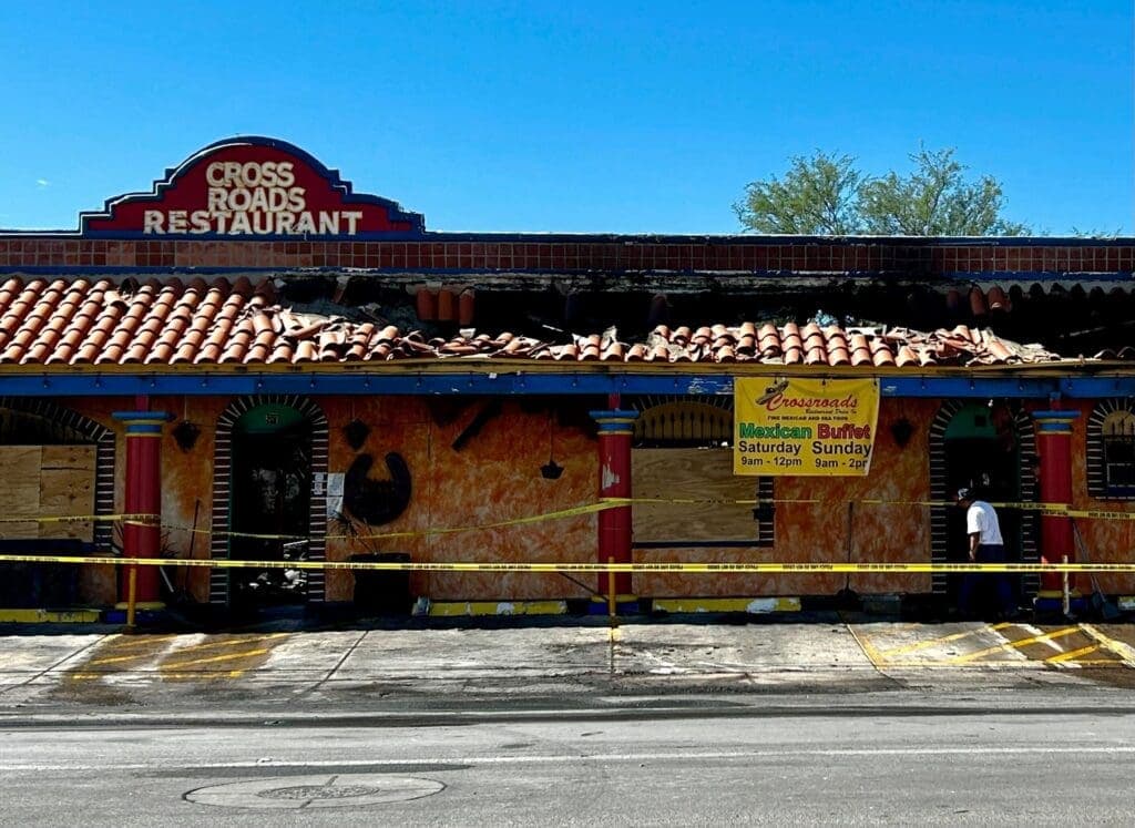 a building with graffiti on the side of a road
