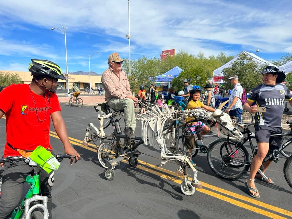 a group of people riding on the back of a motorcycle
