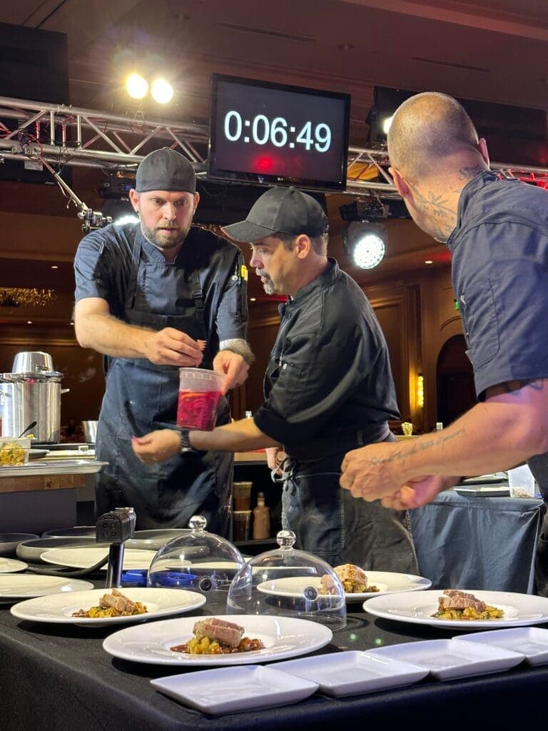 a group of people preparing food on a table
