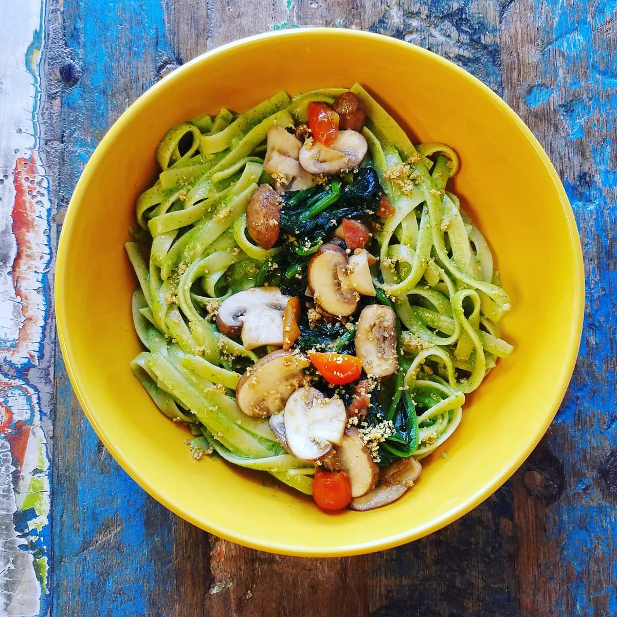 Fettuccine tossed in cilantro sauce topped with sauteed mushrooms and spinach with house-made vegan parmesan (Photo courtesy of Desert Island Eatery on Facebook)