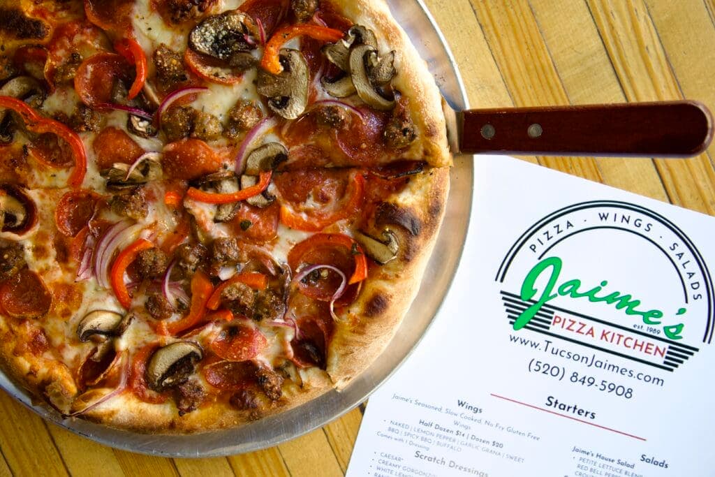 a pizza sitting on top of a wooden table