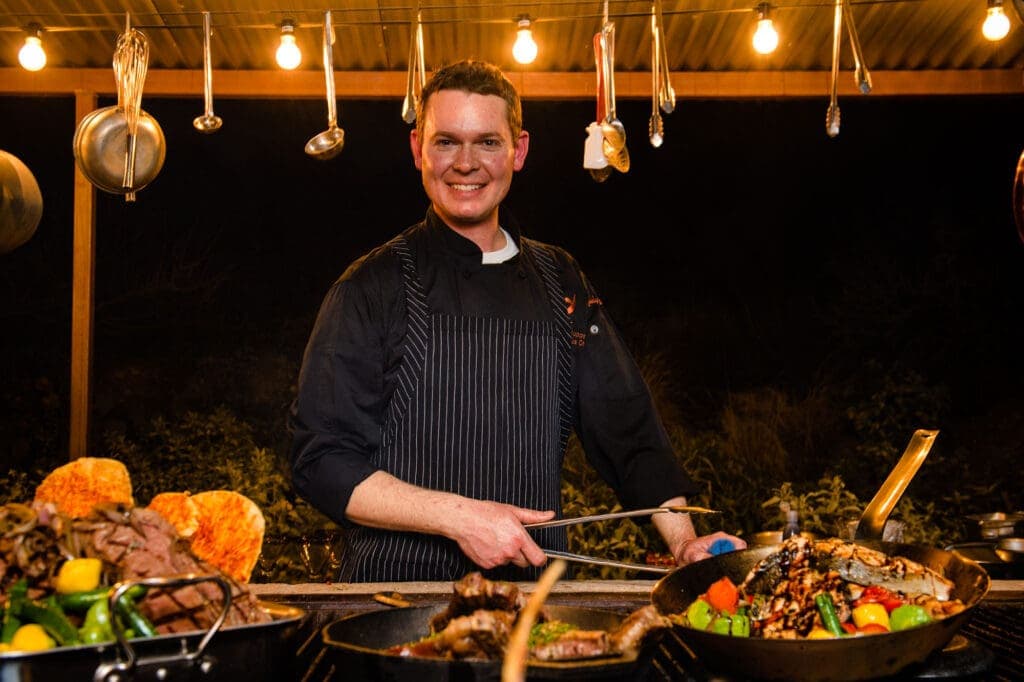 a man cooking food on a table