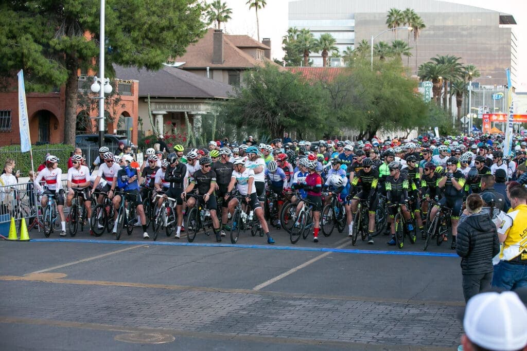a group of people walking down the street in front of a crowd