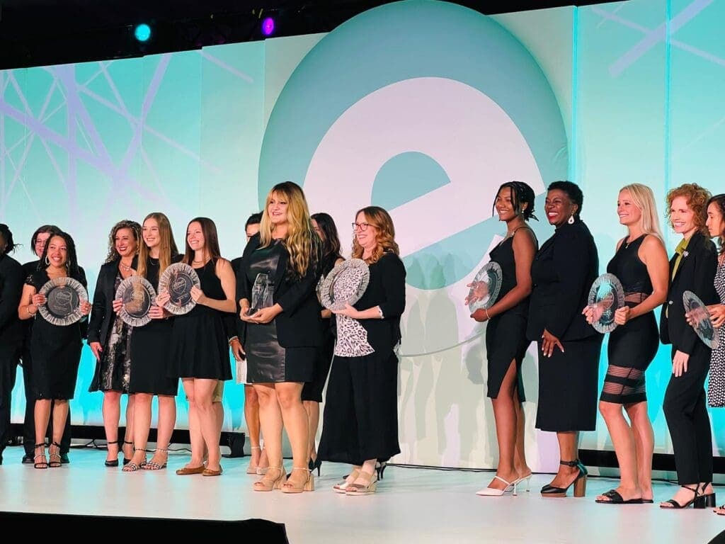 a group of people standing in front of a crowd posing for the camera