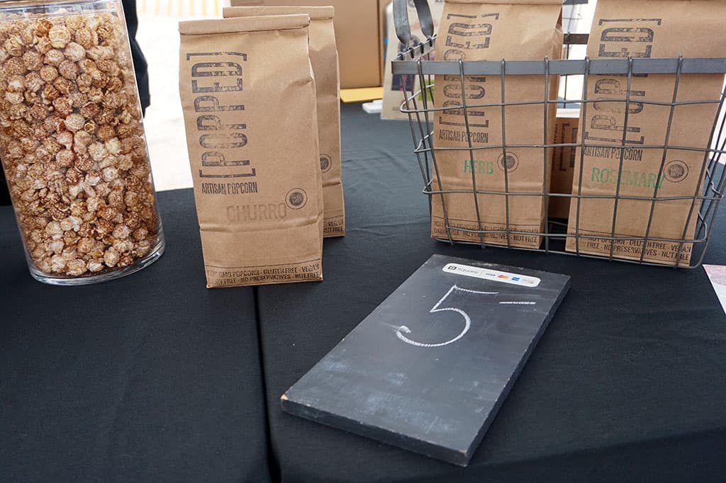 Packaged goods and samples of POPPED popcorn. (Photo by Jennifer Rothschild)