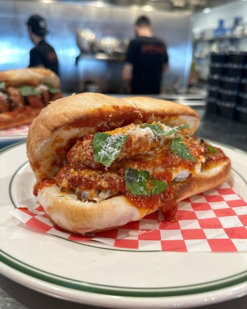 a plate of food with a slice of pizza