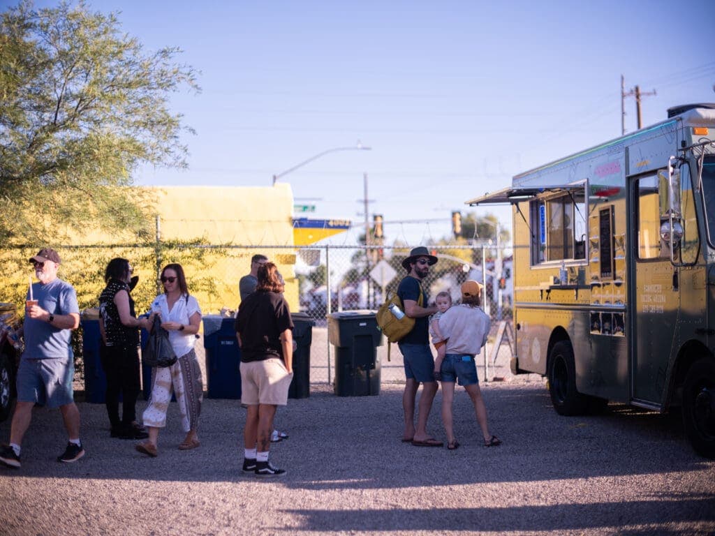 a group of people standing around a bus