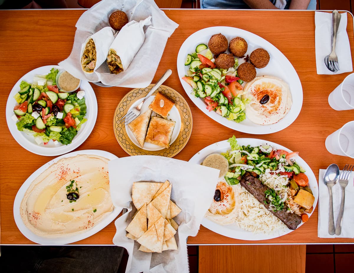 Mediterranean Salad, Chicken Shawarma, assorted sweets, Falafel Plate, hummus, pita, and Kafta Kebab Plate at Caravan Grill (Credit: Jackie Tran)