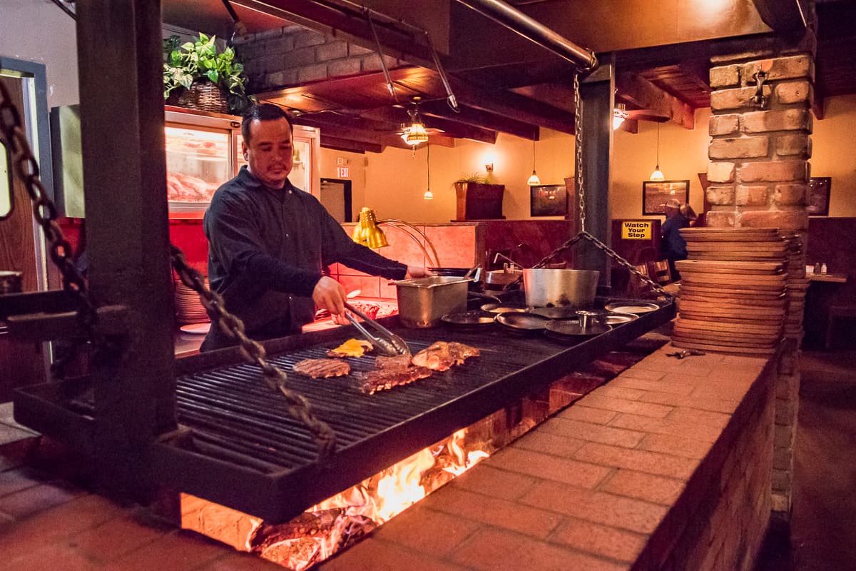 Mario Alva at the grill pit at Silver Saddle Steakhouse (Credit: Jackie Tran)