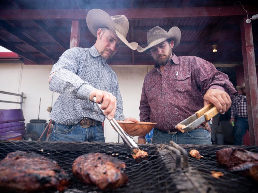 a man cooking food on a grill