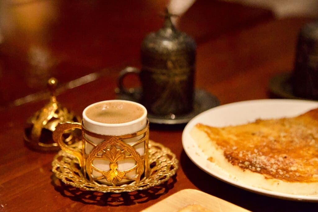 a plate of food and a cup of coffee on a table