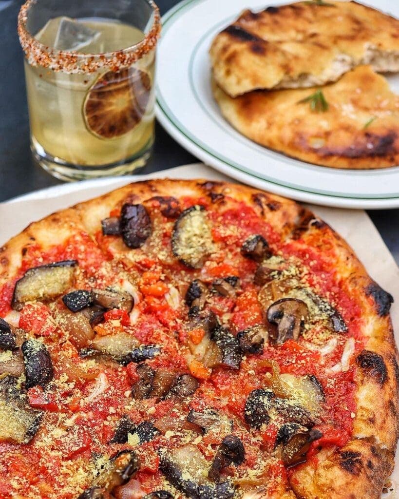 a pizza sitting on top of a plate of food