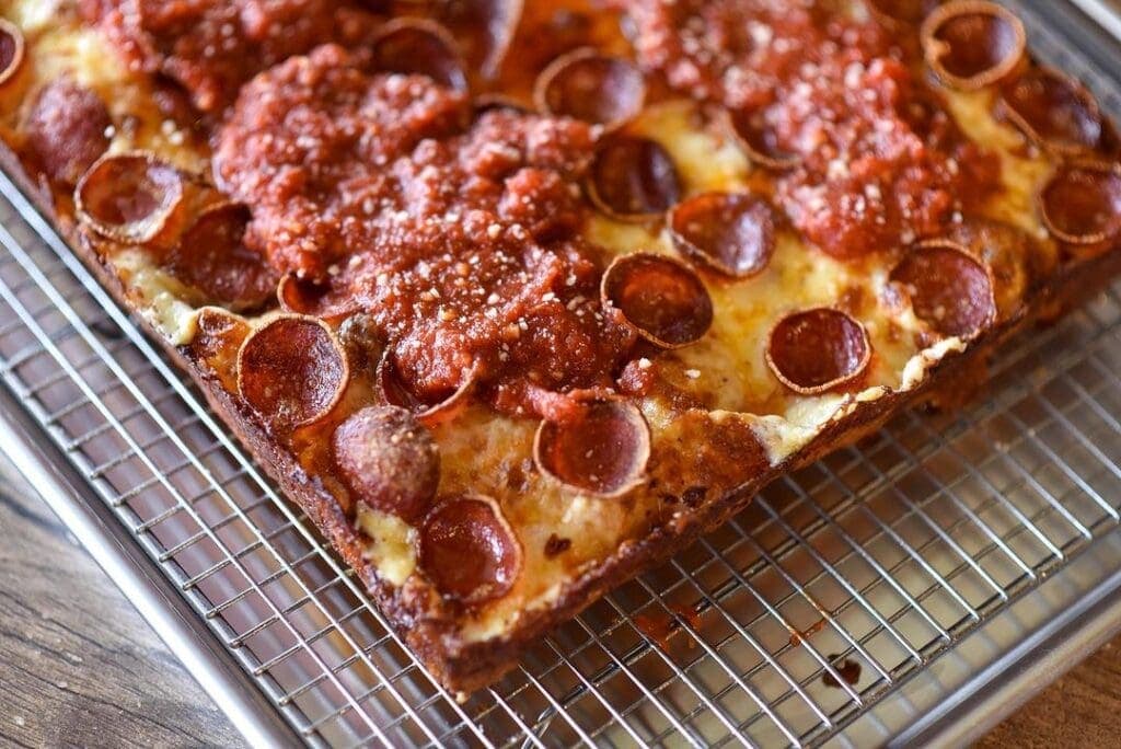 a pizza sitting on top of a metal rack