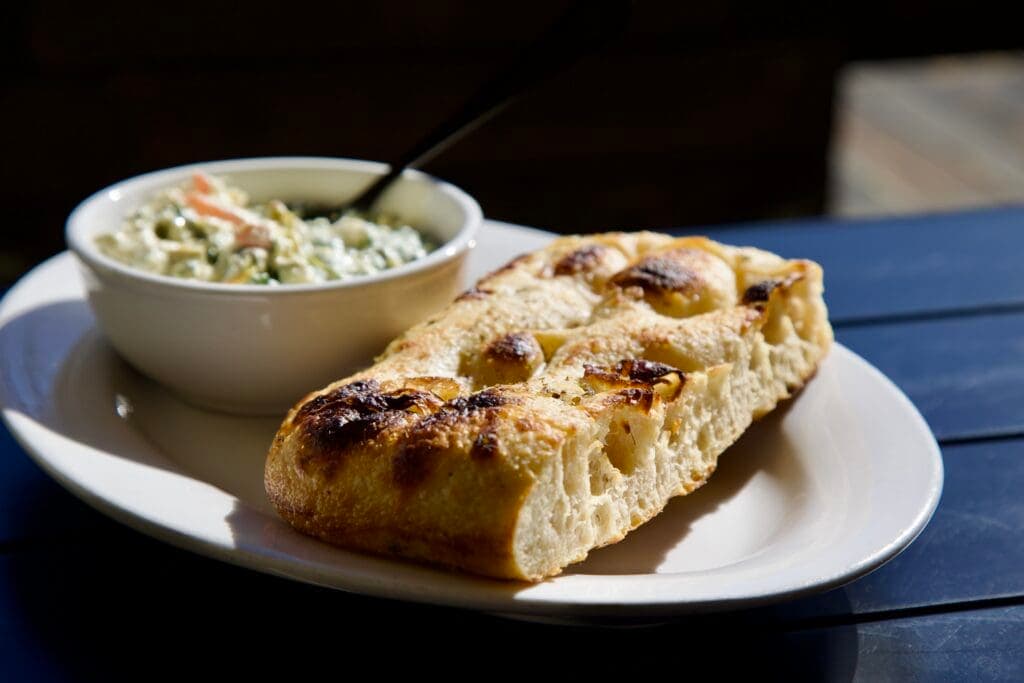 a piece of bread on a plate, focaccia