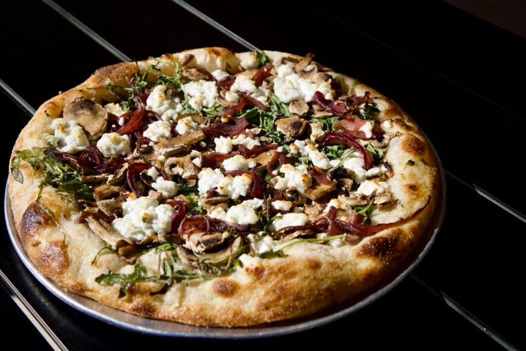a pizza sitting on top of a pan