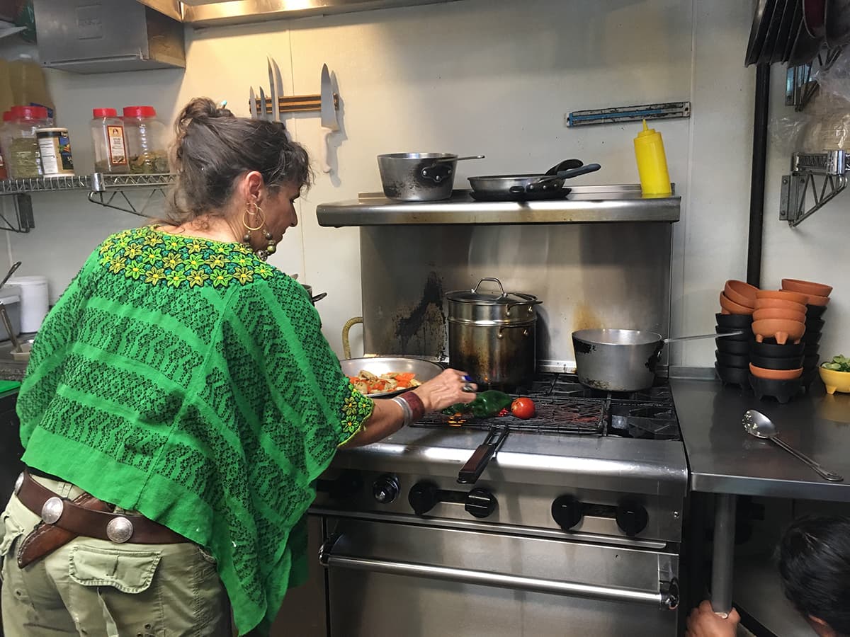 Sandra Davila roasting vegetables at the Little One (Credit: Wren Awry)