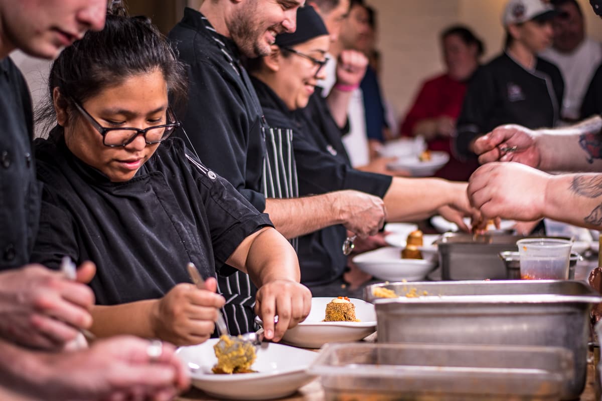 Sous chef Ricazsandria Rances plating at a Gastronomic Union of Tucson (GUT) dinner at the Carriage House (Credit: Jackie Tran)