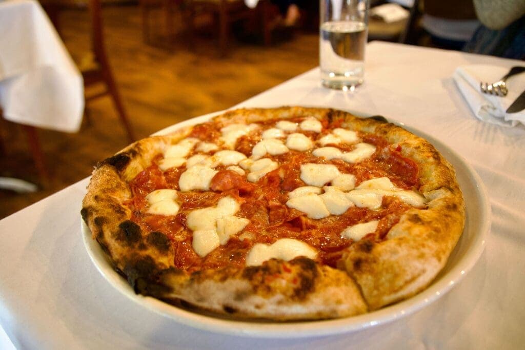 a close up of a slice of pizza on a plate